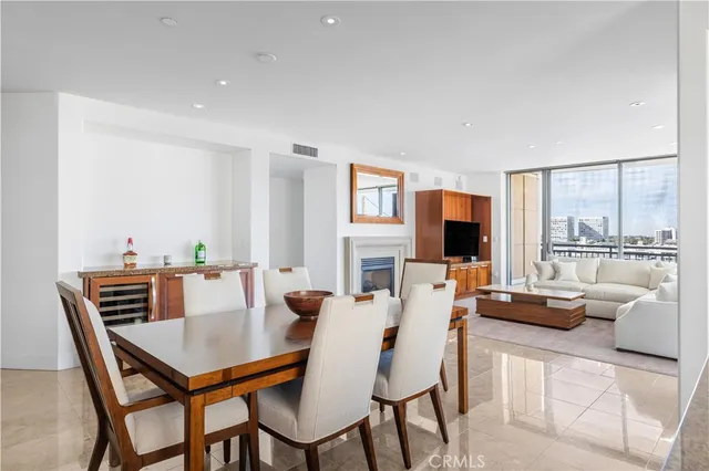 a dining room with furniture and a floor to ceiling window