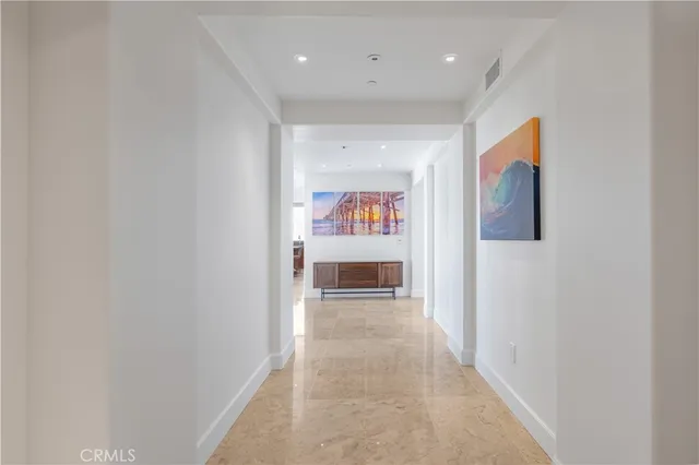 a view of a hallway with wooden floor and entryway