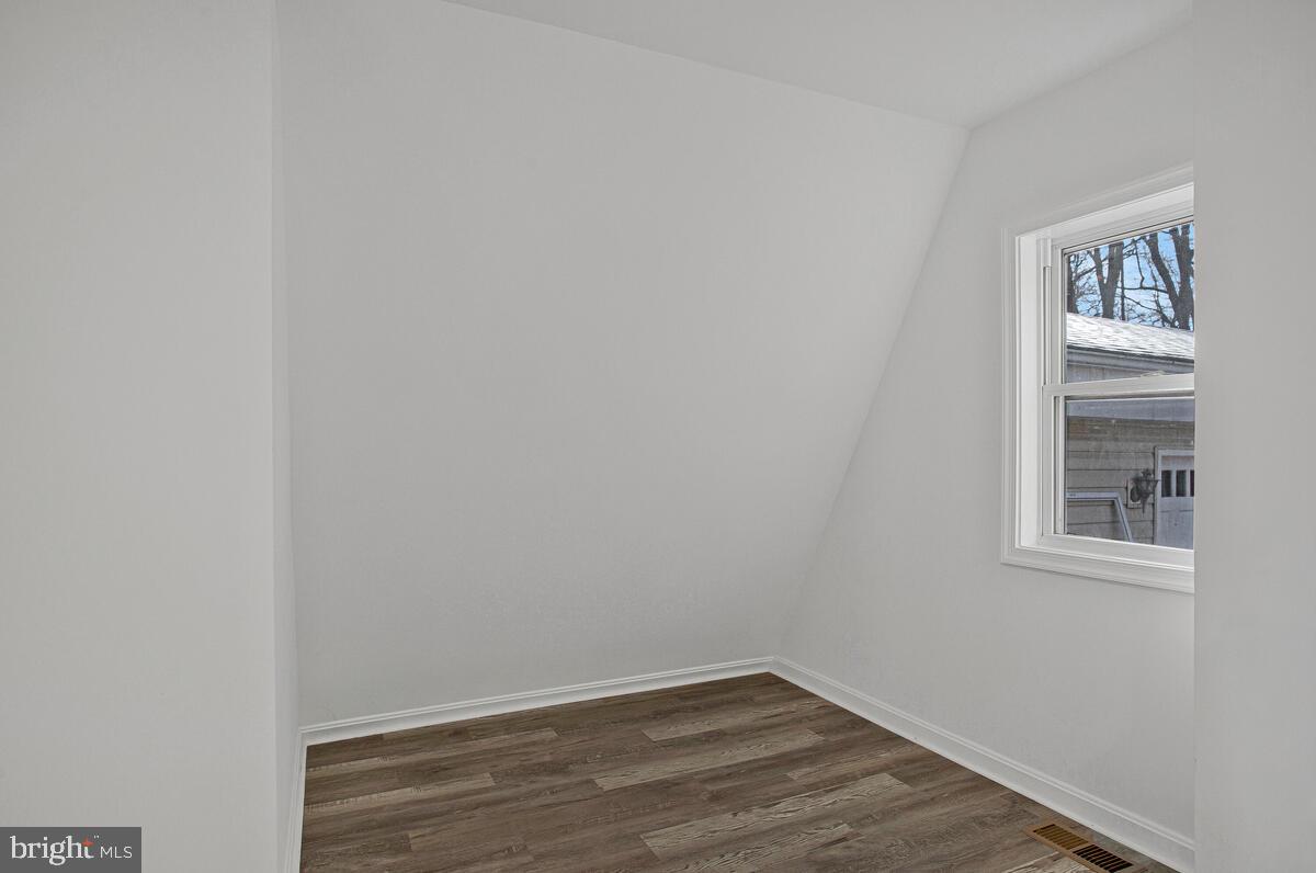 1660 Bay Ridge Road Edgewater, MD 21037 - Photo 15 of 33 a view of an empty room with wooden floor and a window