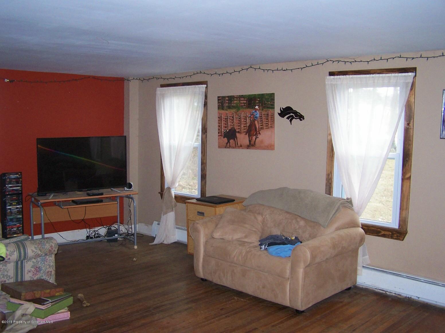 384 State Rte 2024 Montrose, PA 18801 - Photo 20 of 35 a living room with furniture and a flat screen tv
