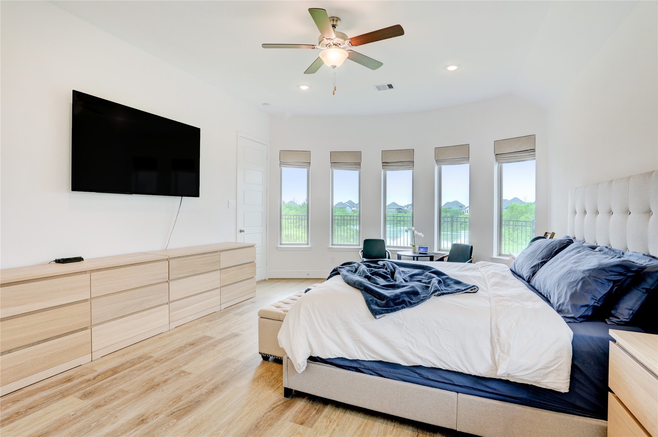 619 Rita Blanca Drive Webster, TX 77598 - Photo 16 of 44 The spacious, well-lit primary bedroom has large windows offering scenic views of the lake.