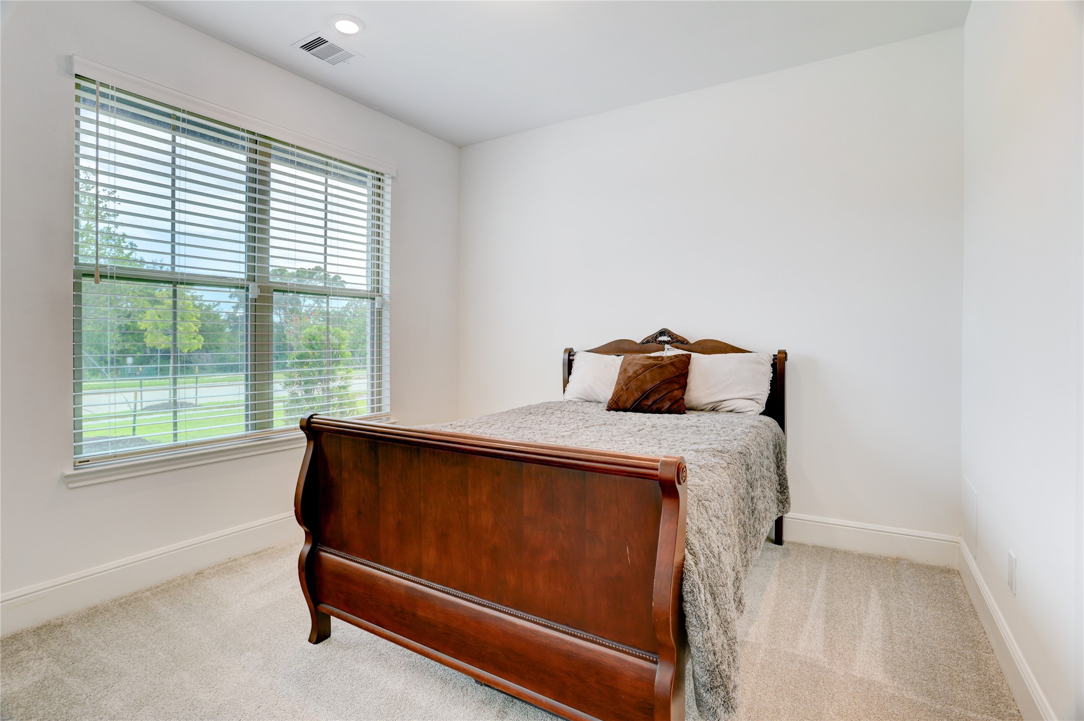 619 Rita Blanca Drive Webster, TX 77598 - Photo 22 of 44 This front secondary bedroom offers a cozy resting place with ample natural light and views of greenery bordering clear creek.