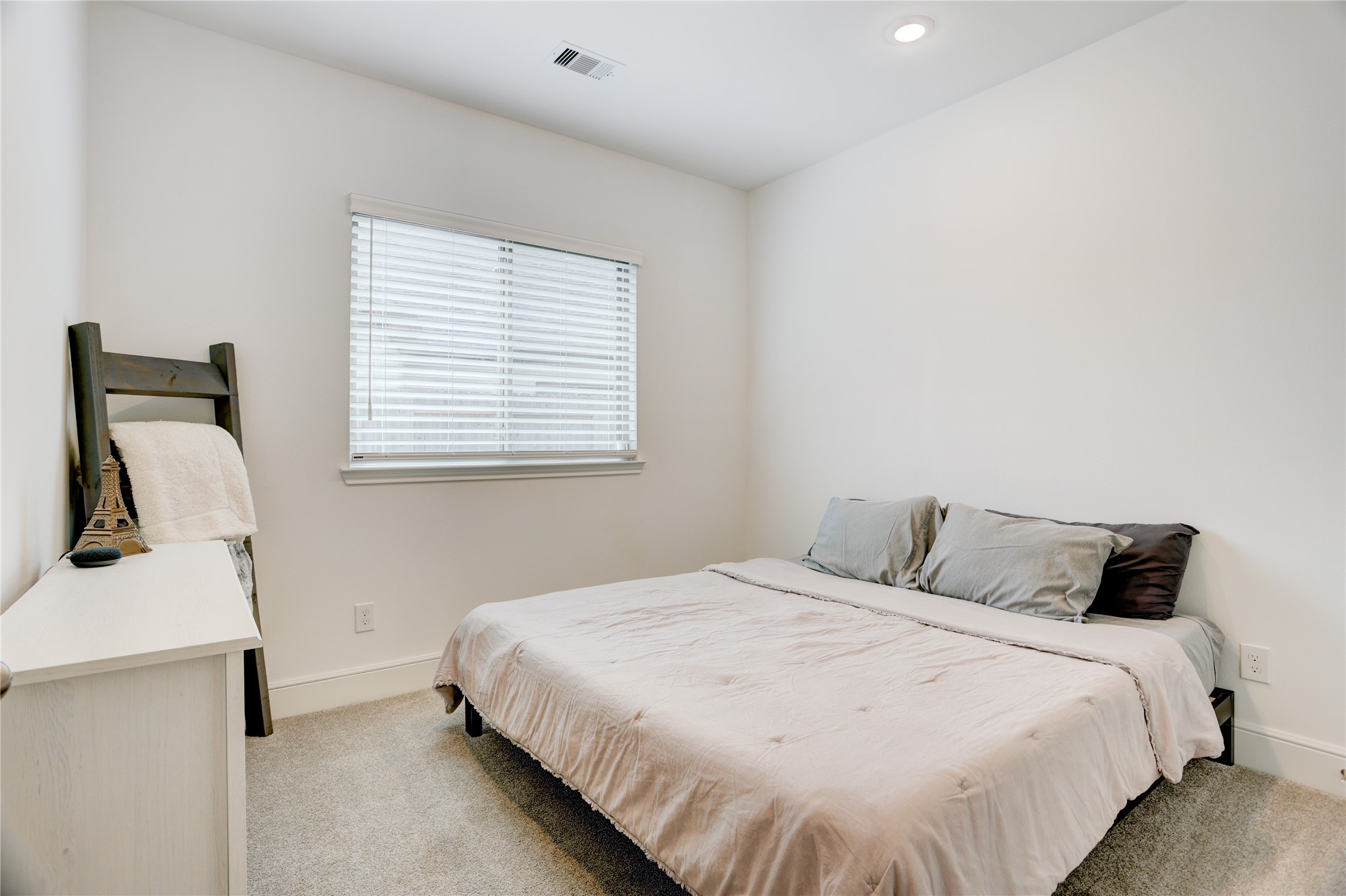 619 Rita Blanca Drive Webster, TX 77598 - Photo 24 of 44 This secondary cozy bedroom features soft carpeting, and a window with blinds for natural light control.