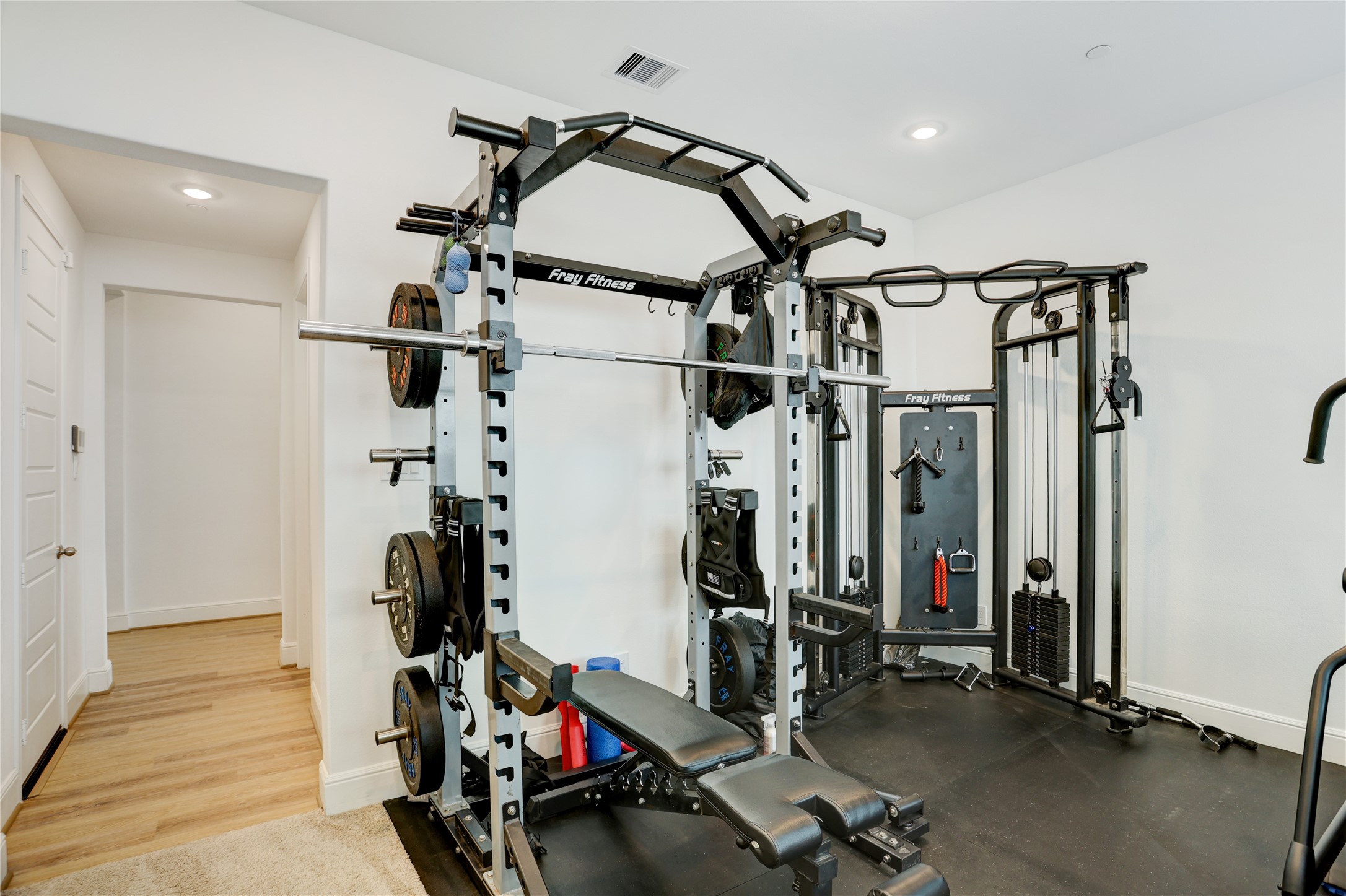 619 Rita Blanca Drive Webster, TX 77598 - Photo 25 of 44 The bonus room features a well-equipped home gym with a multi-functional workout station, complete with weights and various exercise accessories for the fitness enthusiast.