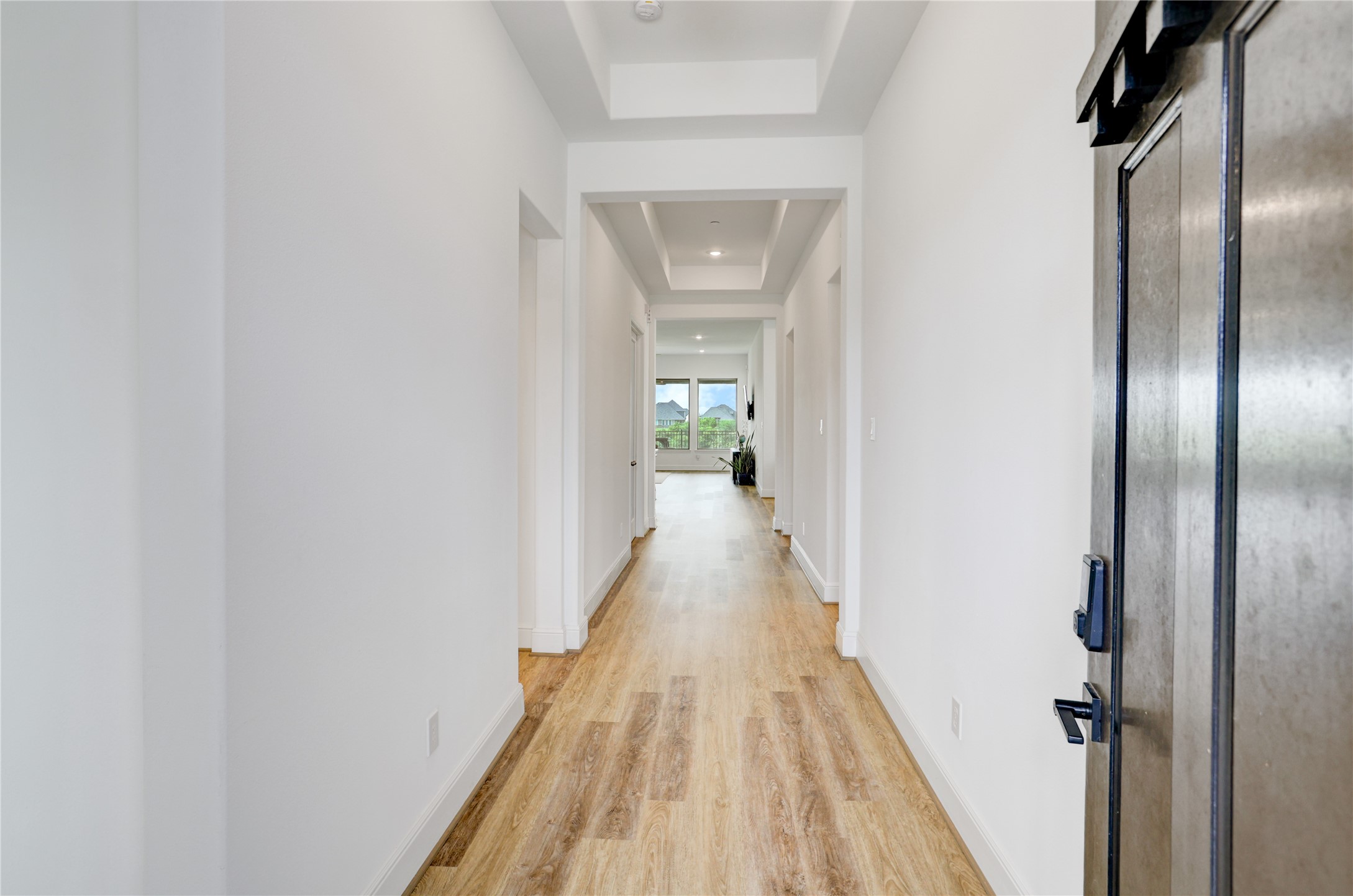 619 Rita Blanca Drive Webster, TX 77598 - Photo 4 of 44 A bright and inviting entry is enhanced with a 8' mahogany door with smart lock, warm plank flooring, and trayed ceilings.