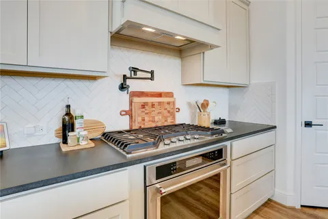 a kitchen with sink attached with living room