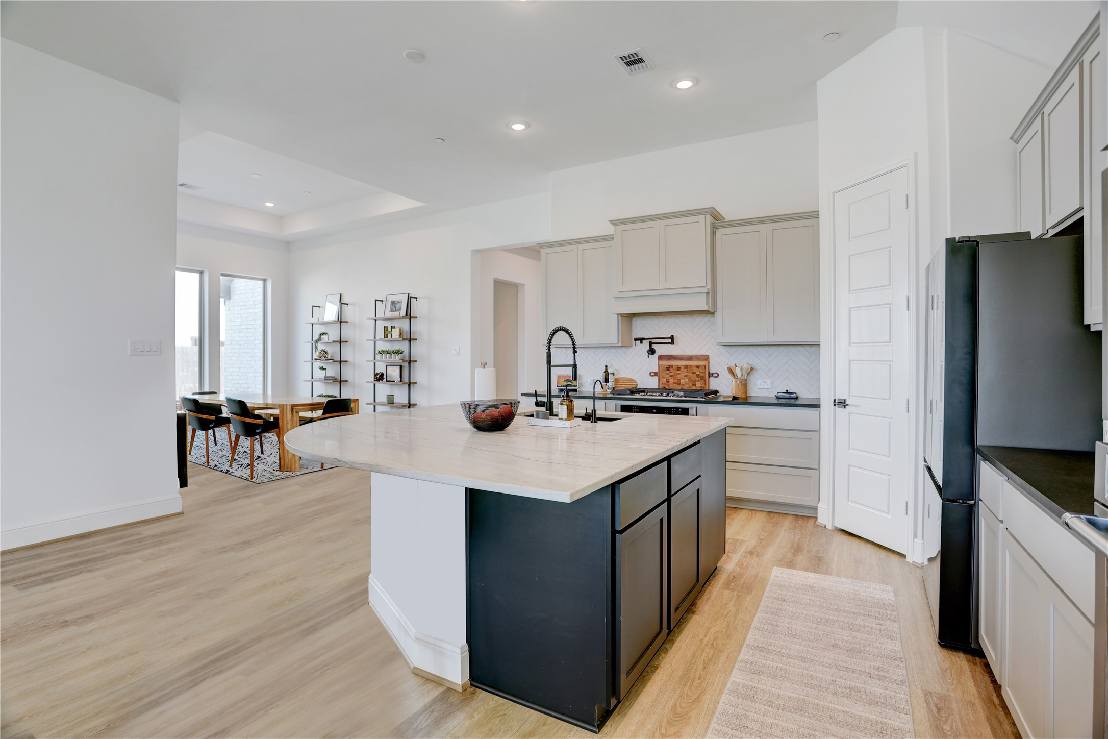 619 Rita Blanca Drive Webster, TX 77598 - Photo 9 of 44 The contrasting kitchen island is balanced by the surrounding cabinetry and counters and the walk in pantry with 8' door offers must-have storage.