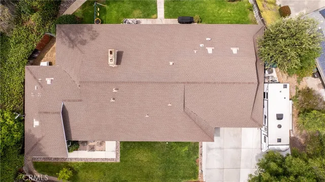 an aerial view of a house with a yard