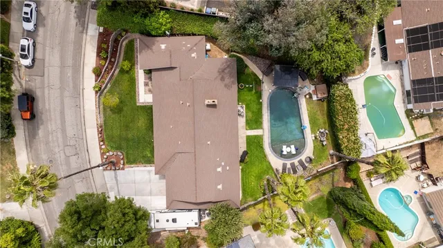 an aerial view of residential house with outdoor space and swimming pool