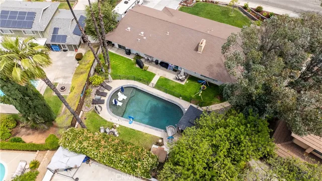 an aerial view of a house with a garden and trees