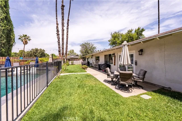 a view of a backyard with sitting area
