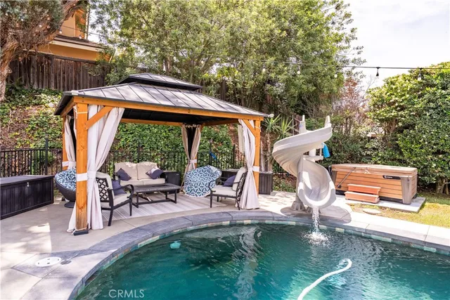 a view of a patio with a table chairs and a slide