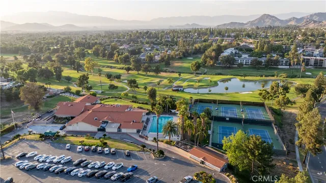 an aerial view of residential houses with outdoor space and river view