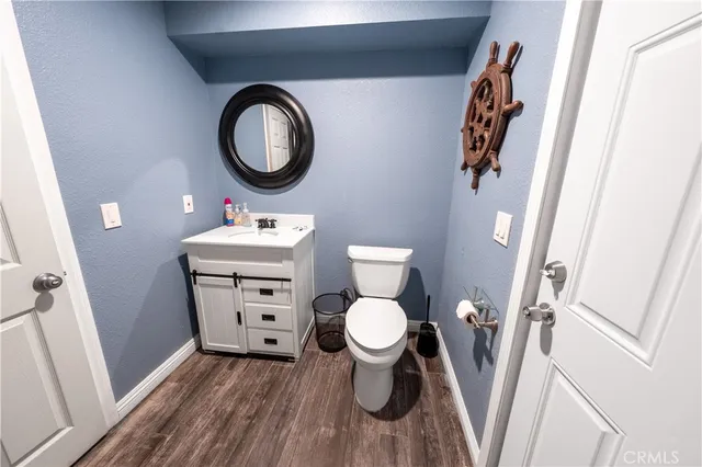 a hallway with painting on the wall and a potted plant