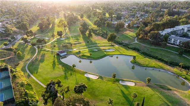 an aerial view of residential houses with outdoor space and a lake view