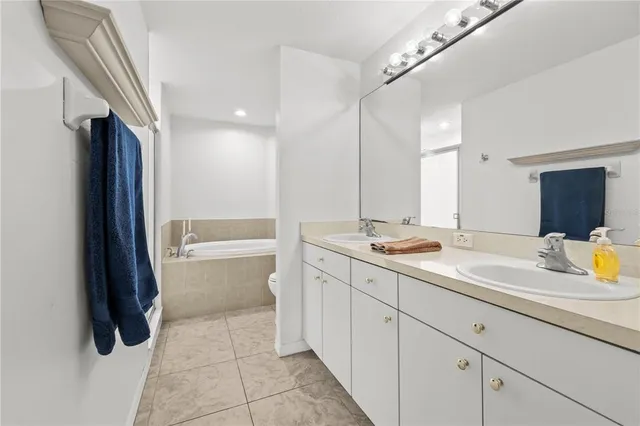 a bathroom with a sink a toilet a mirror and shower