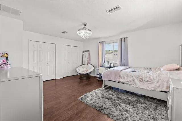 a bedroom with a bed and a chandelier