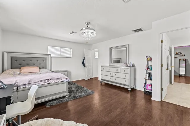 a bedroom with a bed and a chandelier