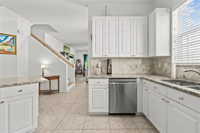 a kitchen with a stove sink and cabinets