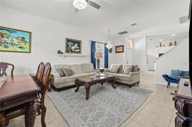 a living room with furniture wooden floor and a chandelier