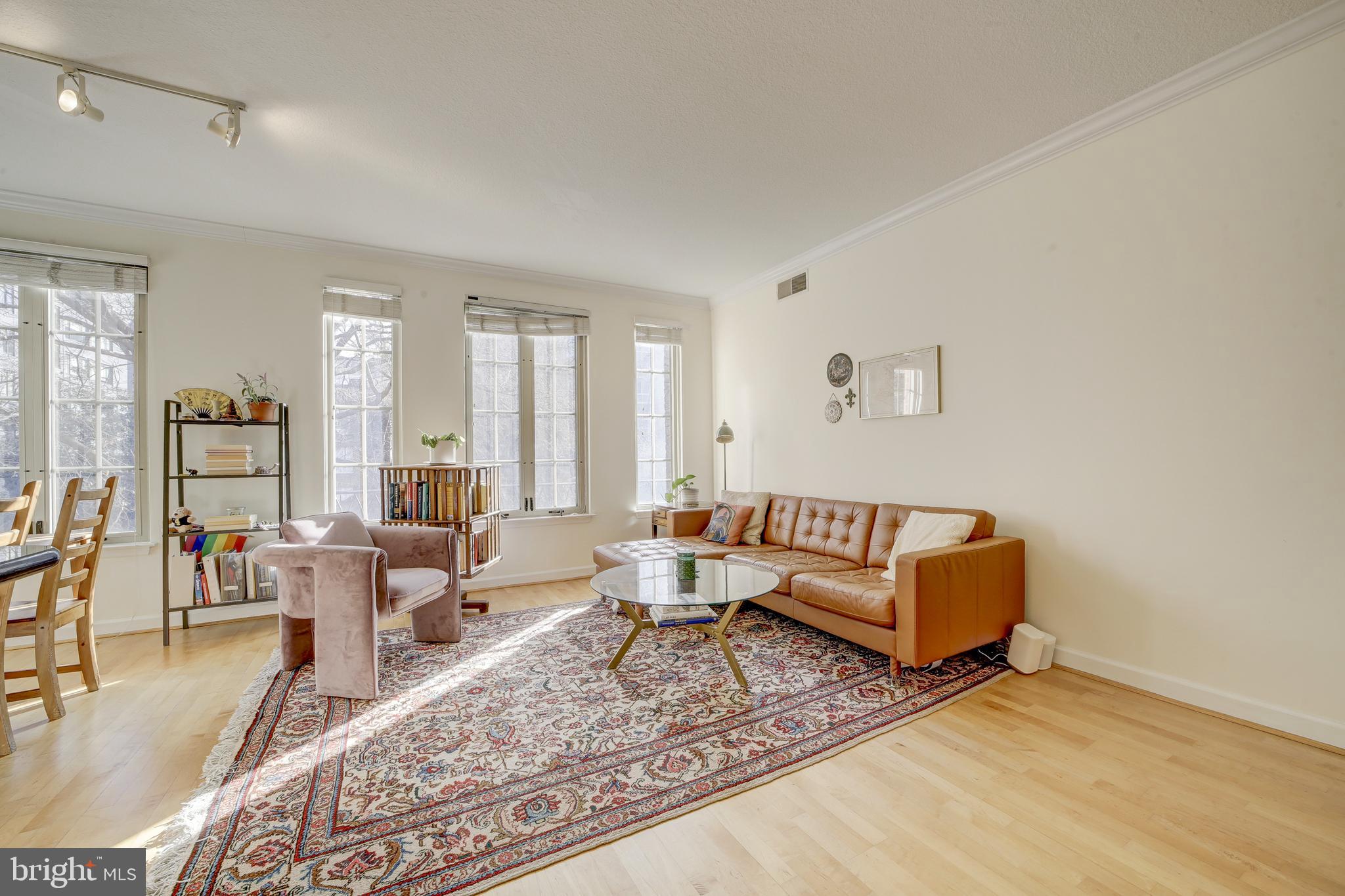 a living room with furniture wooden floor and a table