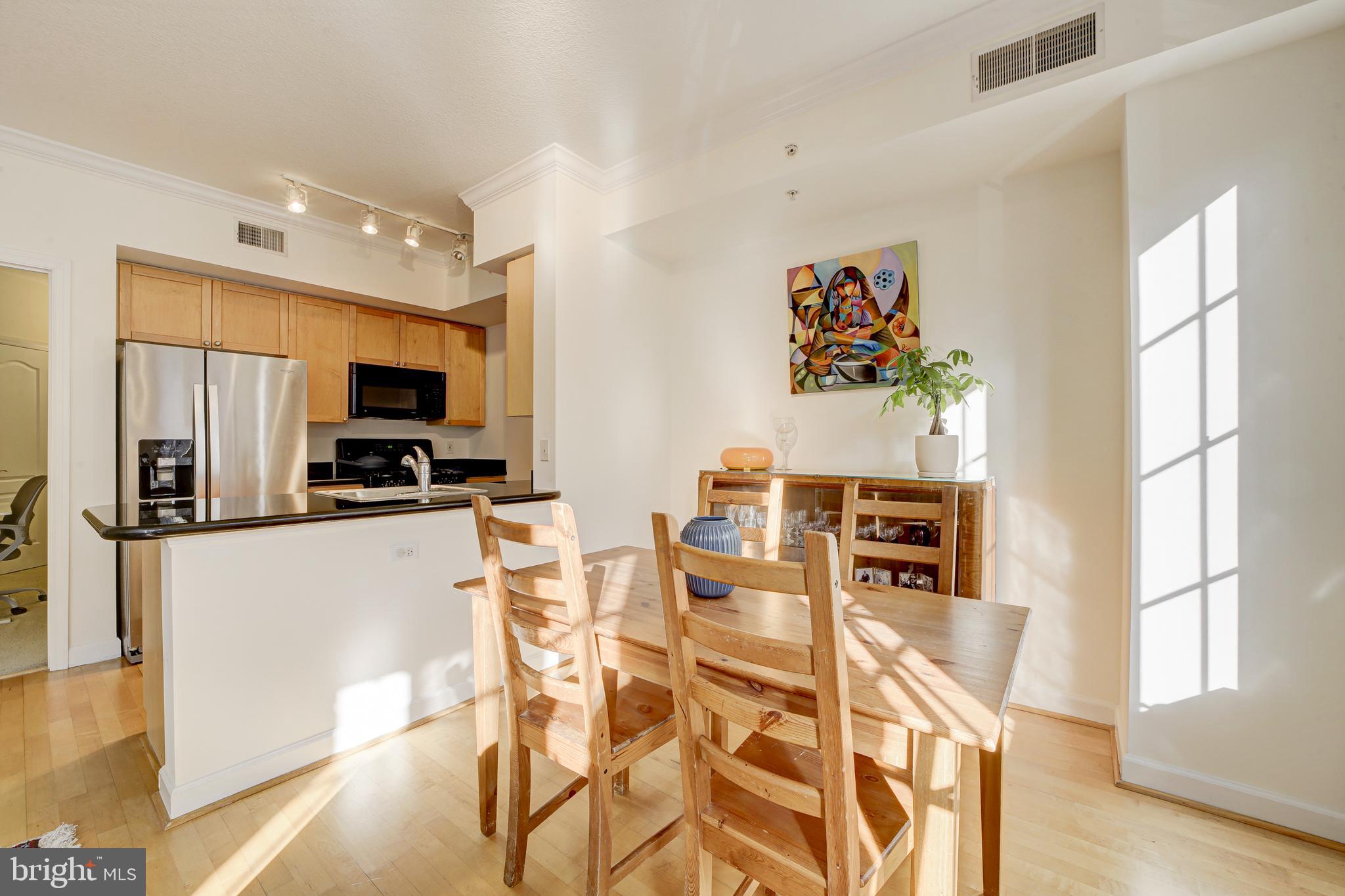 1441 Rhode Island Avenue Northwest, Unit 419 Washington, DC 20005 - Photo 11 of 25 a kitchen with stainless steel appliances a microwave a stove and refrigerator