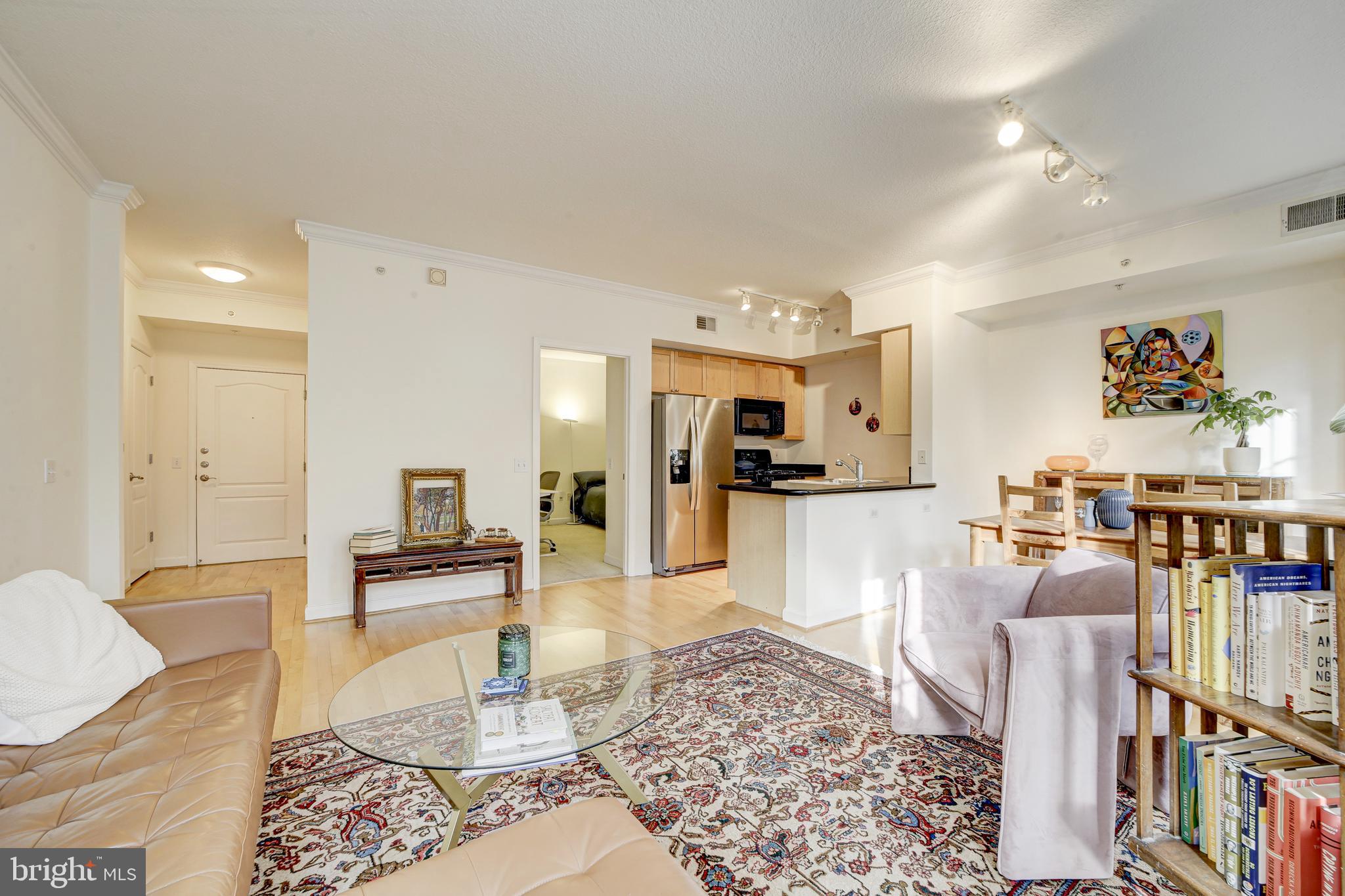 1441 Rhode Island Avenue Northwest, Unit 419 Washington, DC 20005 - Photo 14 of 25 a living room with lots of furniture and kitchen view