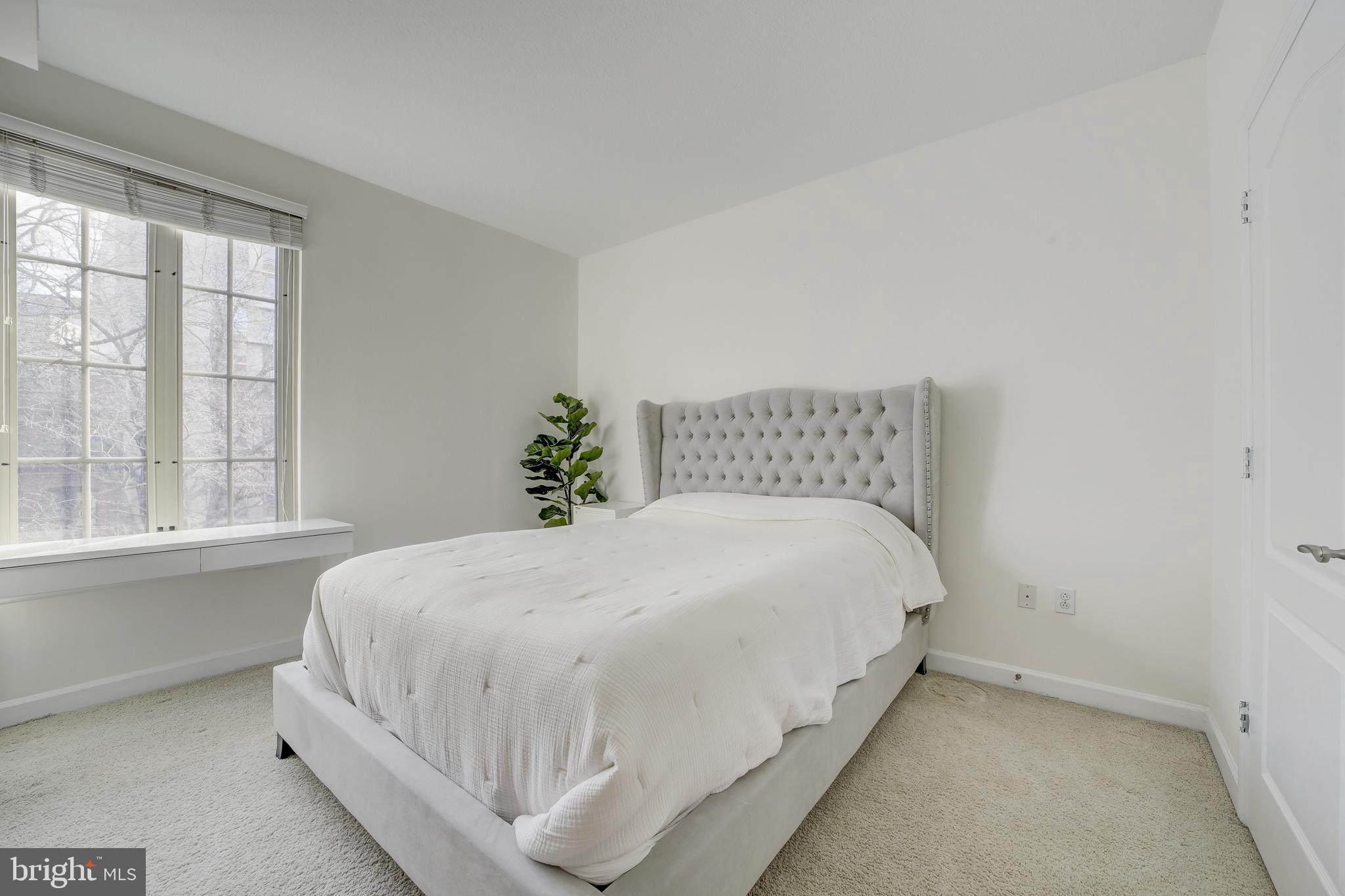 1441 Rhode Island Avenue Northwest, Unit 419 Washington, DC 20005 - Photo 20 of 25 a large bed sitting in a bedroom next to a window