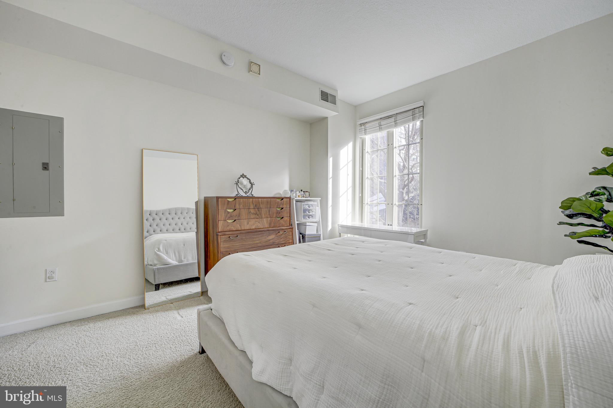 1441 Rhode Island Avenue Northwest, Unit 419 Washington, DC 20005 - Photo 21 of 25 a bedroom with a bed and a cabinets