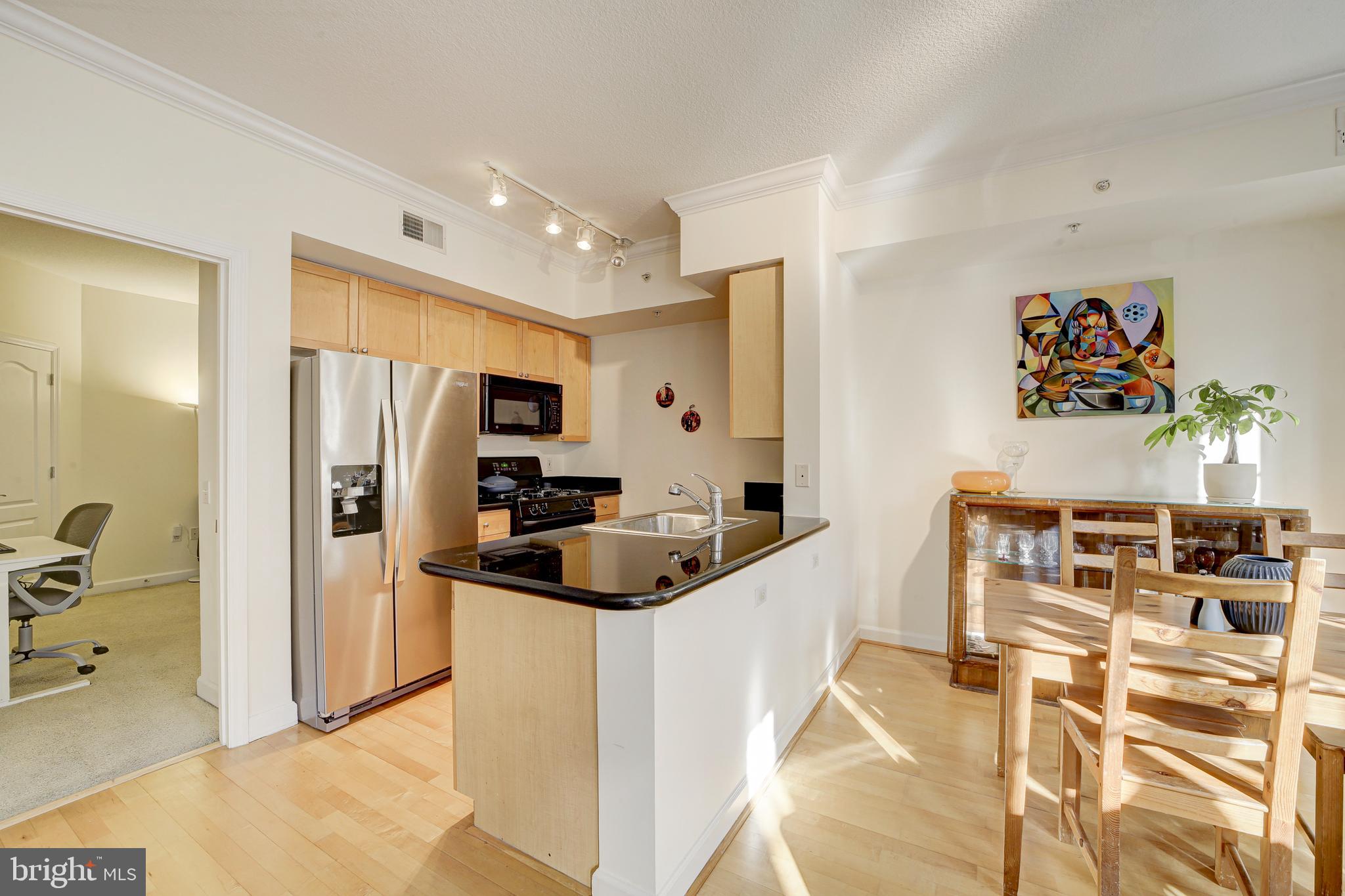 1441 Rhode Island Avenue Northwest, Unit 419 Washington, DC 20005 - Photo 5 of 25 a kitchen that has a lot of cabinets and refrigerator in it