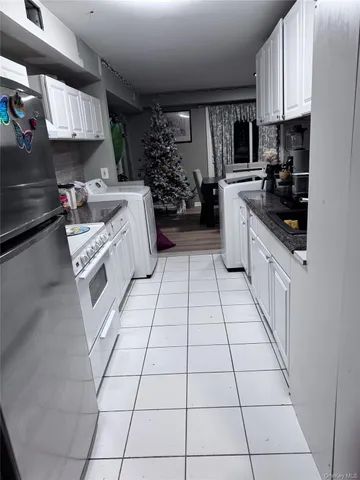 a kitchen with stainless steel appliances a sink a stove a microwave and cabinets