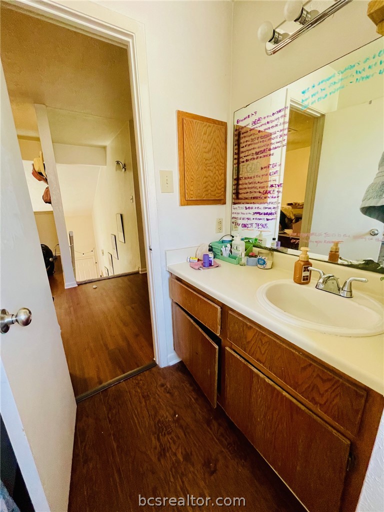 922 Spring Loop, Unit A College Station, TX 77840 - Photo 19 of 20 Bathroom featuring vanity and wood finished floors