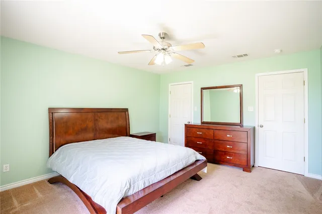 a bedroom with a bed and a dresser