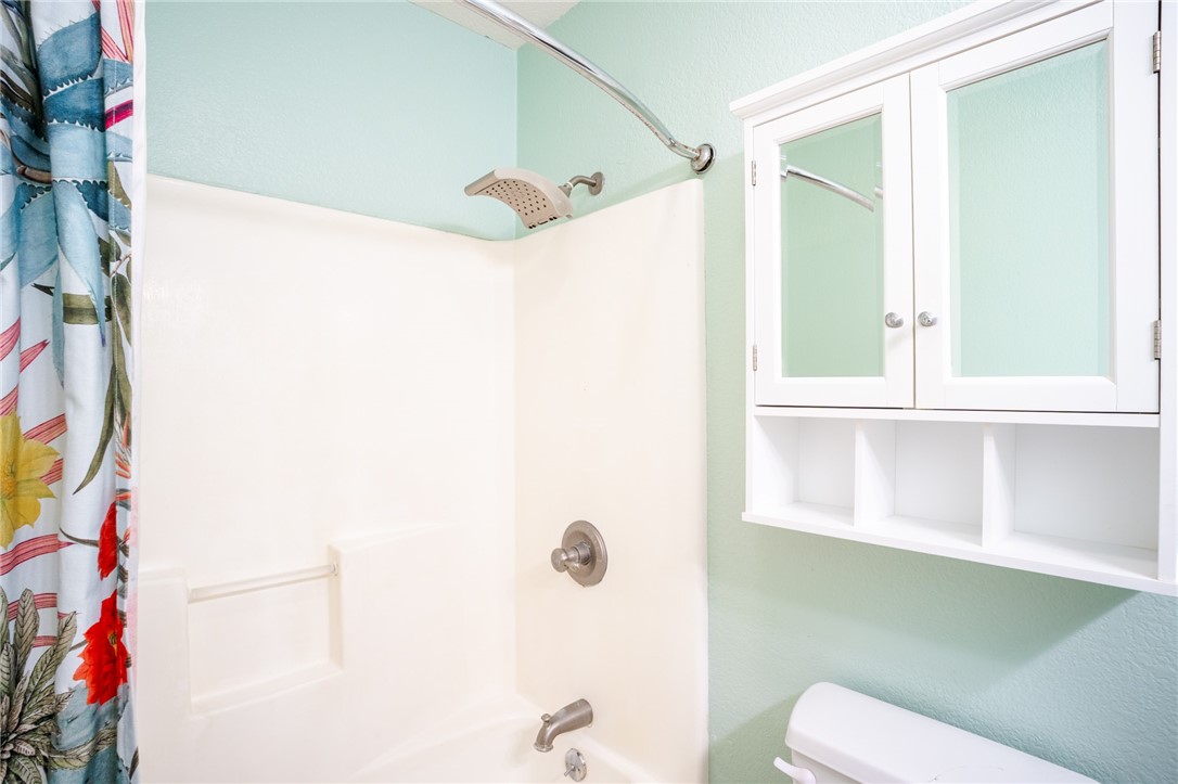 1016 Clark Street Mexia, TX 76667 - Photo 14 of 36 a bathroom with a sink a toilet and shower