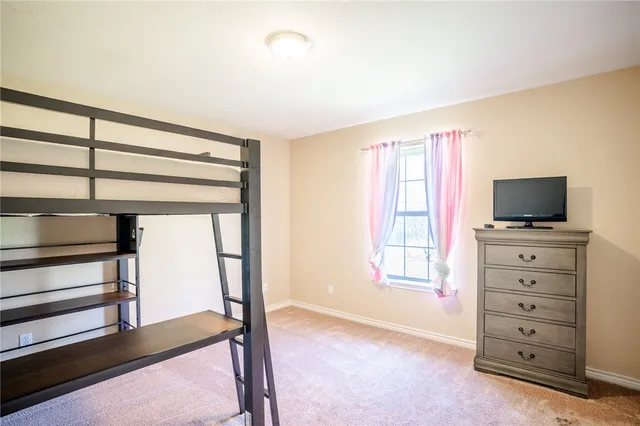 a view of room with window and flat screen tv