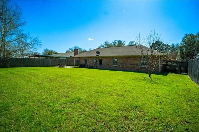 a patio with a table and chairs under an umbrella