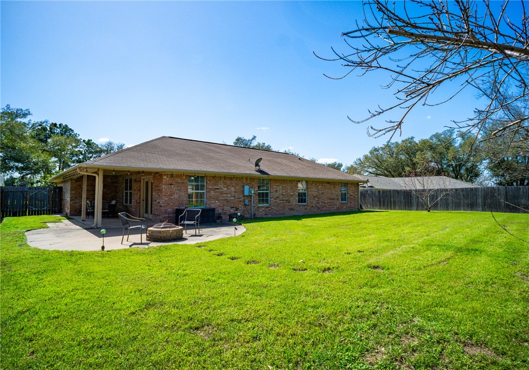 1016 Clark Street Mexia, TX 76667 - Photo 23 of 36 a patio with a table and chairs under an umbrella