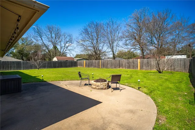 a view of a patio with a table and chairs
