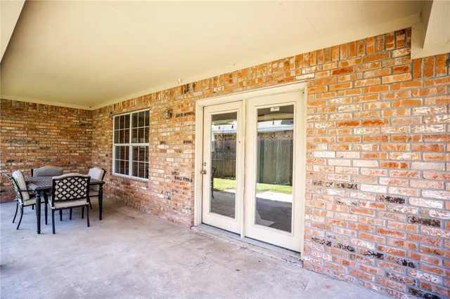 a aerial view of a house with table and chairs under an umbrella