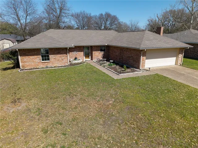 a aerial view of a house with swimming pool and a yard