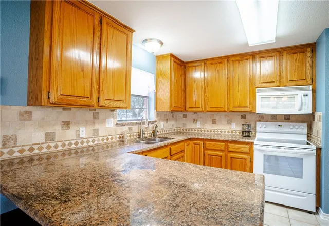 a kitchen with stainless steel appliances granite countertop a sink and cabinets