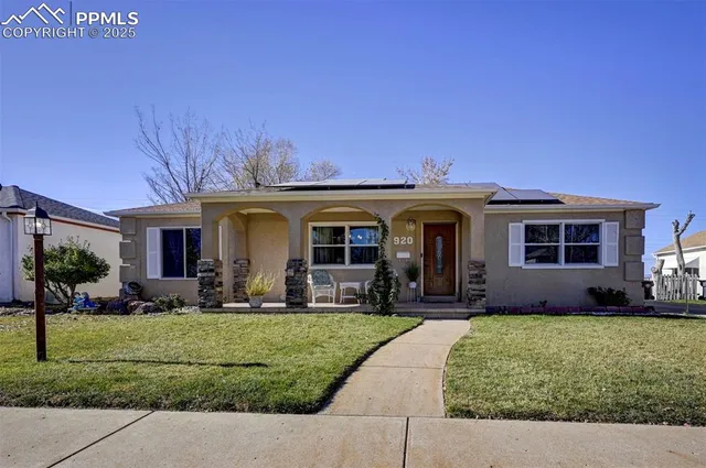 a front view of a house with a yard and porch