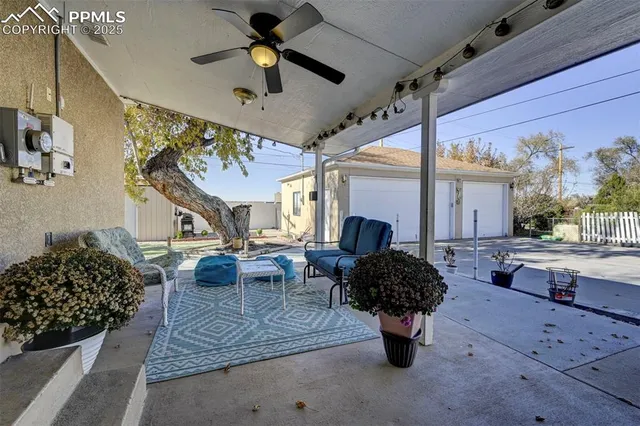 a view of a patio with table and chairs and potted plants