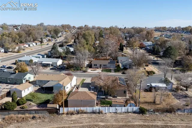 an aerial view of a house with a yard