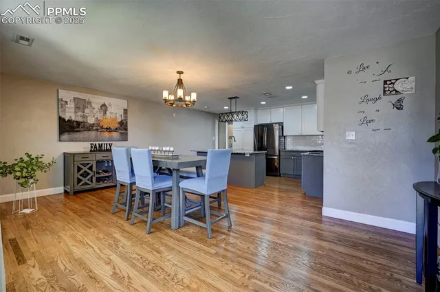 a view of a dining room with furniture and chandelier