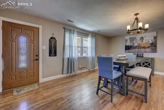 a view of a dining room with furniture window and wooden floor