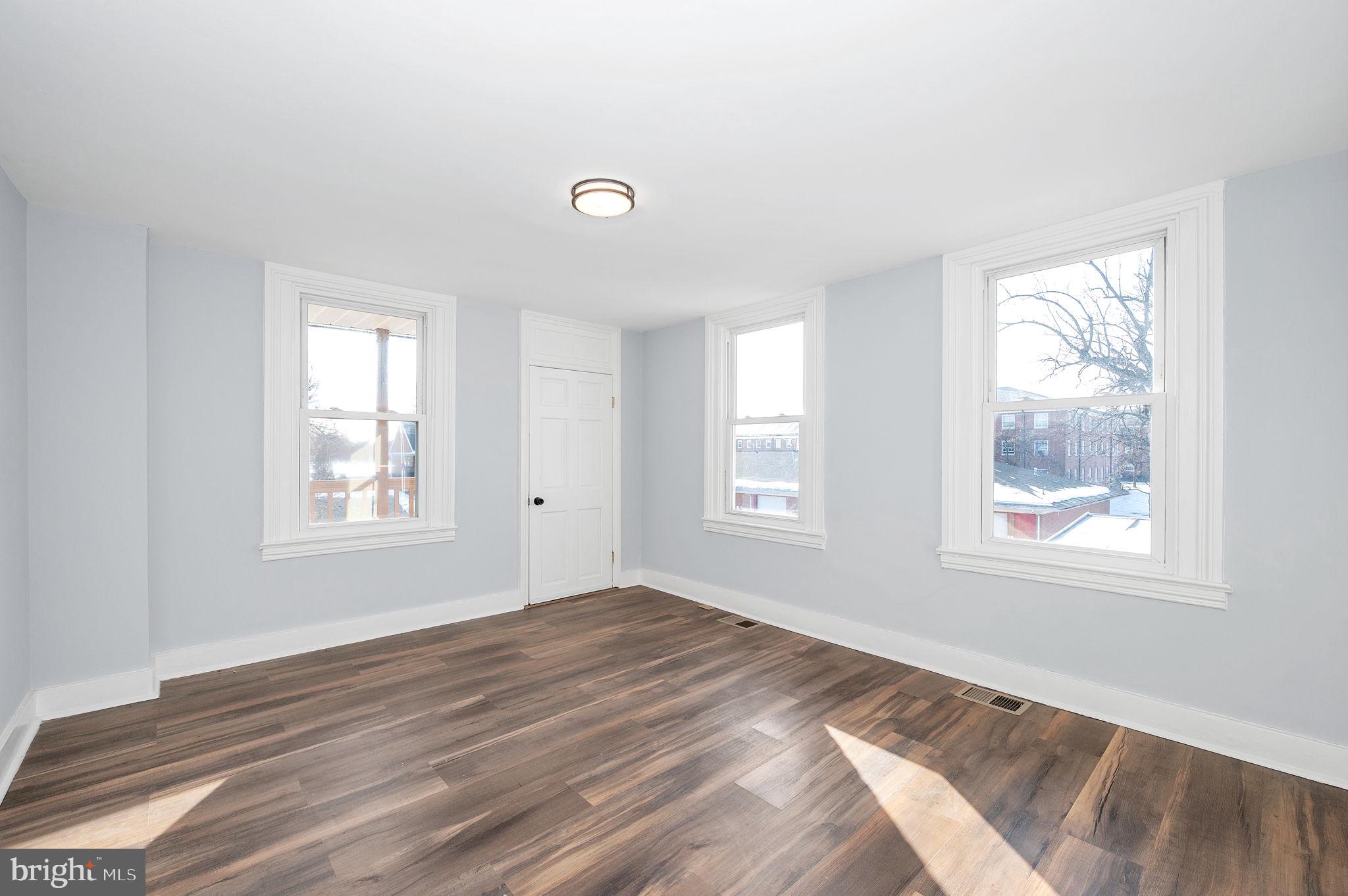 230 South Market Street, Unit 3 Frederick, MD 21701 - Photo 11 of 22 a view of a bedroom with wooden floor and windows