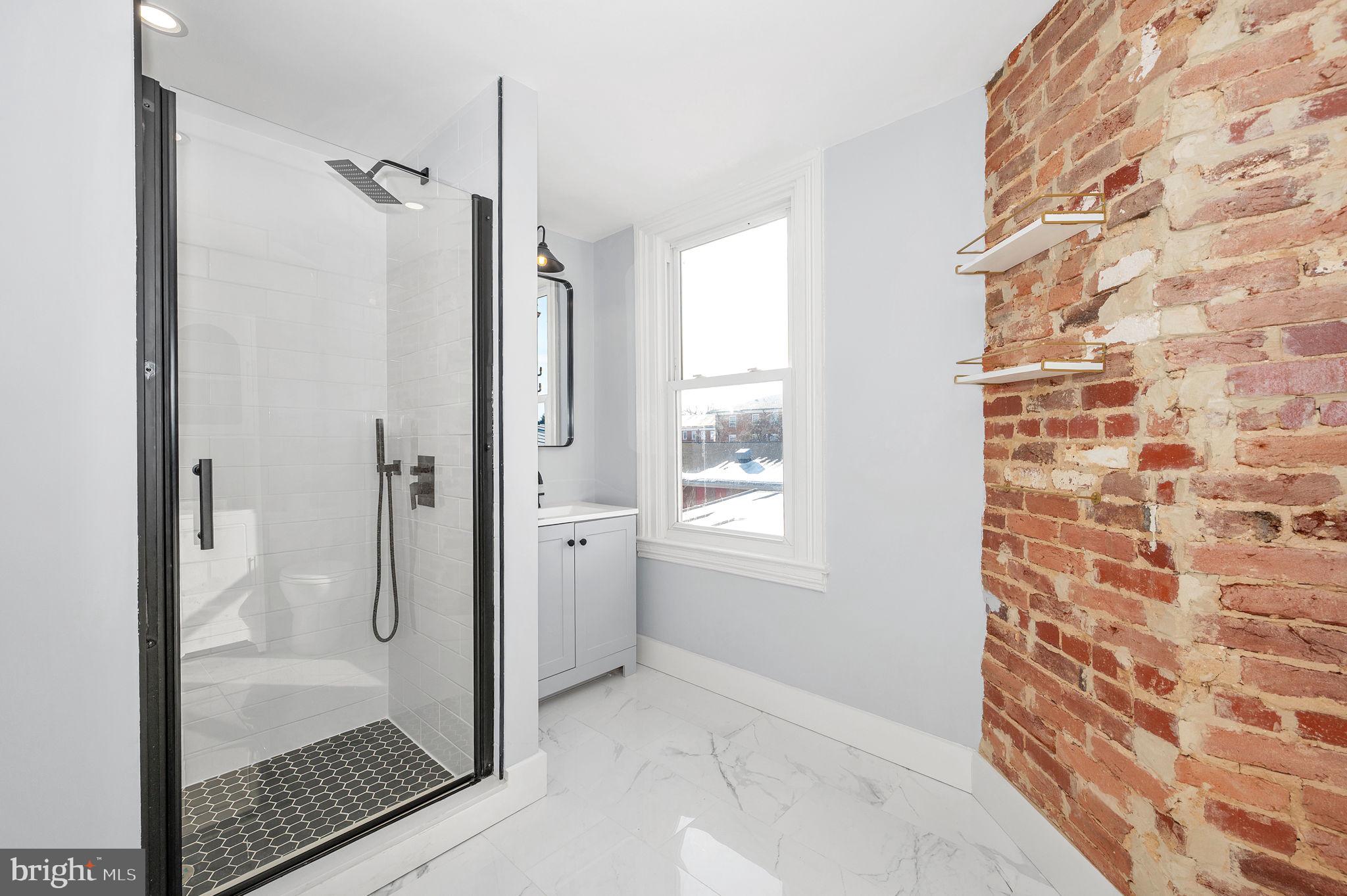 230 South Market Street, Unit 3 Frederick, MD 21701 - Photo 13 of 22 a bathroom with a glass shower door