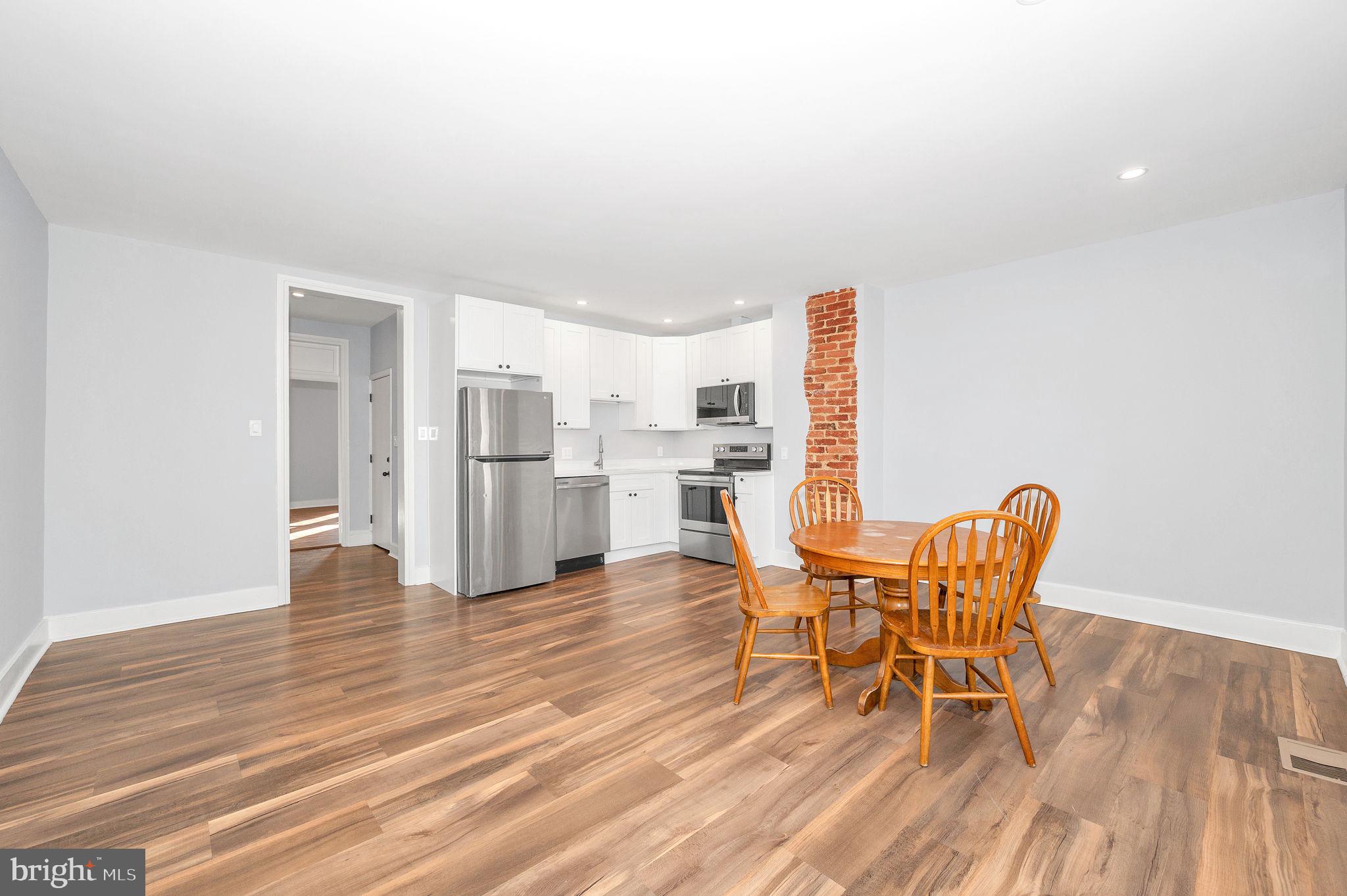 230 South Market Street, Unit 3 Frederick, MD 21701 - Photo 4 of 22 a dining room with furniture and wooden floor