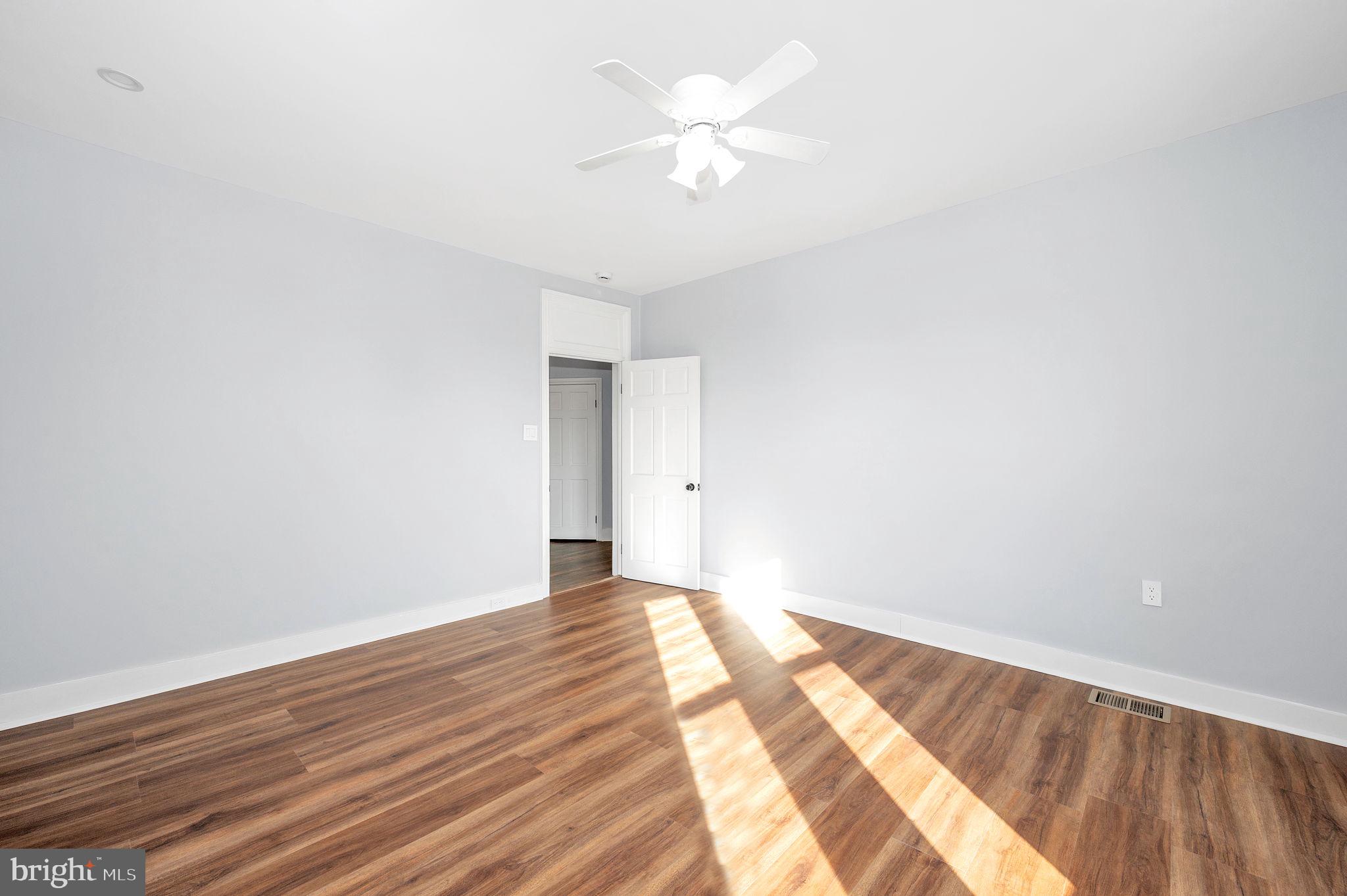 230 South Market Street, Unit 3 Frederick, MD 21701 - Photo 8 of 22 a view of a room with wooden floor and a ceiling fan